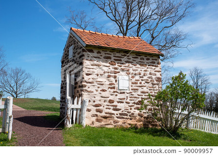 Colonial American stone smokehouse in idyllic landscape Colonial American stone smokehouse in idyllic landscape 90009957