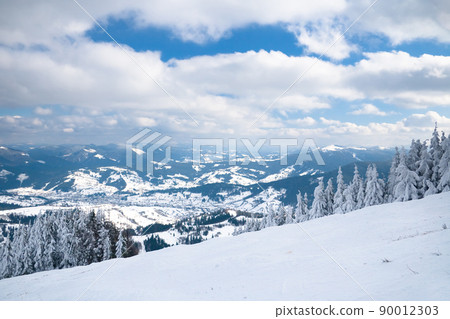 View from the top of mountain on forest in frost and low cloud. 90012303