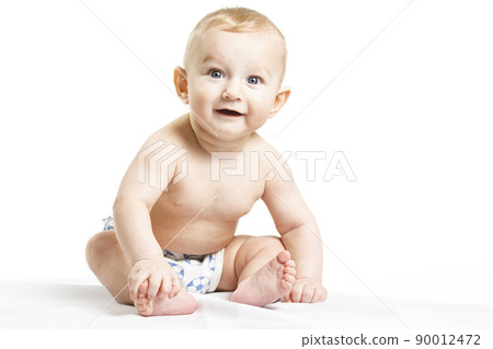 Smiling baby-boy in a diaper sitting on the floor. On a white background with reflection 90012472