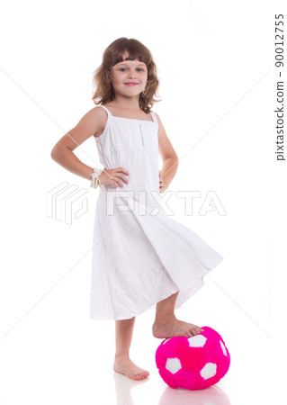 Toddler girl in action playing soccer with world globe isolated on white background 90012755