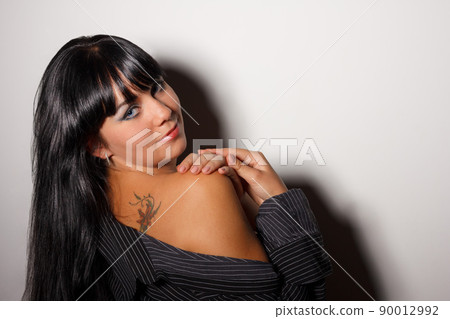 Beautiful and mature adult caucasian woman with red lips, dark hair and brown eyes wearing a black leather jacket, striped black and white top and a lace hat. Beautiful and mature adult caucasian woman with red lips, dark hair and brown eyes wearing a black leather jacket, striped black and white top and a lace hat. 90012992