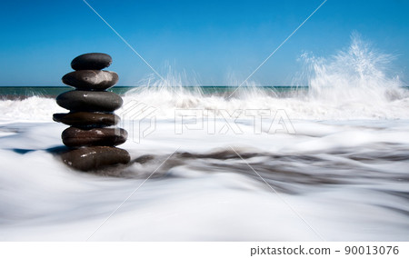 Wonderful nature Shining and polished stones piled on the shore with many polished stones on the Crimean peninsula. The background is the sea, a pebble beach with some other islands. 90013076