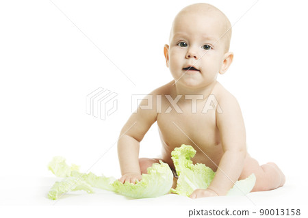 Naked baby in diaper is playing with fresh organic vegetables and fruits isolated on a white background. Little kid biting a fresh green head of cabbage. Healthy food for children concept. Naked baby in diaper is playing with fresh organic vegetables and fruits isolated on a white background. Little kid biting a fresh green head of cabbage. Healthy food for children concept. 90013158