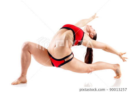 Sporty beautiful young woman practicing yoga, doing lunge exercise, Revolved Side Angle Pose, , working out wearing red and black sportswear, studio full length, isolated white background. Sporty beautiful young woman practicing yoga, doing lunge exercise, Revolved Side Angle Pose, , working out wearing red and black sportswear, studio full length, isolated white background. 90013257