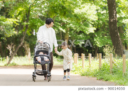 Dad and kids playing in the park 90014030
