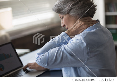 Upset stressed mature woman suffering from neck ache Upset stressed mature woman suffering from neck ache 90014128