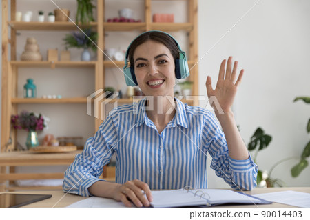 Happy young business blogger in wireless headphones giving webinar 90014403