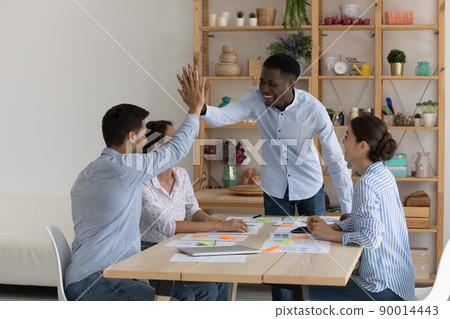 Happy coach giving motivating high five to intern for work Happy coach giving motivating high five to intern for work 90014443