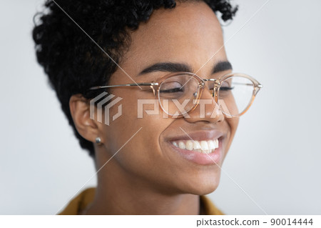 Closeup face African woman in glasses and wide toothy smile Closeup face African woman in glasses and wide toothy smile 90014444