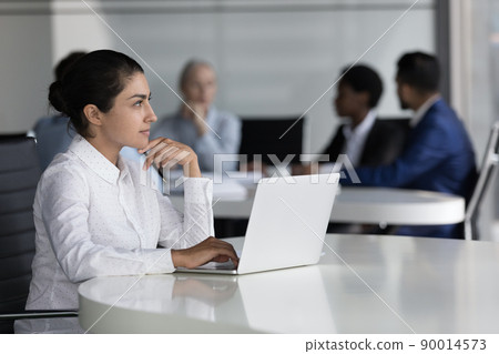 Indian employee thinking over task sit at desk with laptop Indian employee thinking over task sit at desk with laptop 90014573