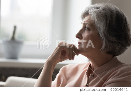 Frustrated mature grey haired 50s woman thinking over bad news Frustrated mature grey haired 50s woman thinking over bad news 90014641