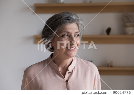 Positive thoughtful senior grey haired lady looking away 90014776