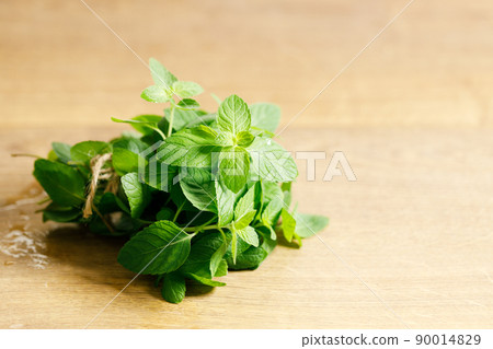 Fresh mint on wooden table. Fresh mint on wooden table. 90014829