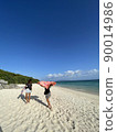 Two tanned women walking in Shirahama under the blue sky 90014986