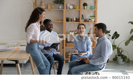 Cheerful excited multiethnic business group brainstorming, sharing funny ideas Cheerful excited multiethnic business group brainstorming, sharing funny ideas 90015193