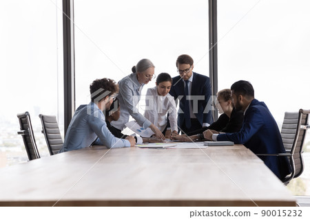 Team of diverse businesspeople discuss financial report at group meeting 90015232