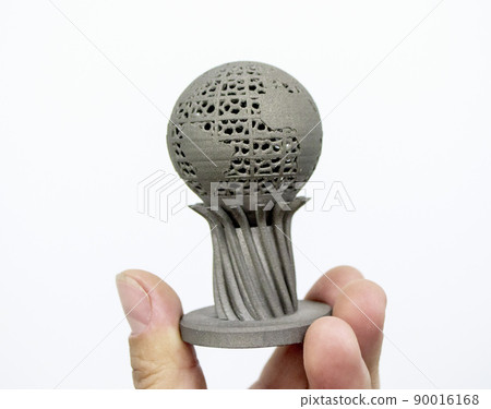 Man holding three-dimensional volumetric model printed on 3D printer for metal. Object printed laser sintering machine for metal. Form printed by technology selective laser melting on metal 3D printer Man holding three-dimensional volumetric model printed on 3D printer for metal. Object printed laser sintering machine for metal. Form printed by technology selective laser melting on metal 3D printer 90016168