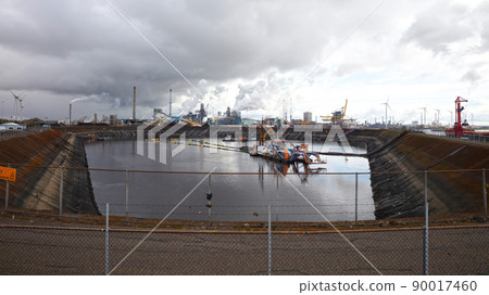 Steel factory plant with chimneys, ship in front 90017460