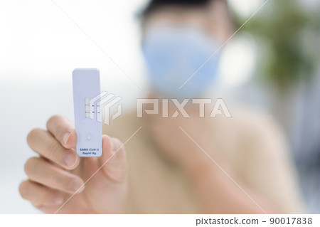 woman holding Rapid Antigen Test kit  COVID19 90017838
