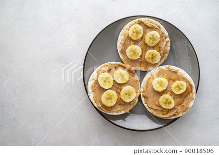 Peanut butter over rice cakes and honey. Healthy protein snack for breakfast 90018506