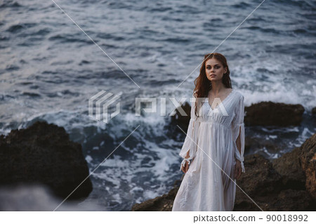 Woman in white dress nature rocky stones waves 90018992