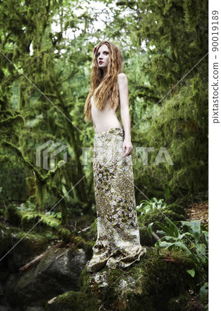 Portrait of romantic woman in fairy forest 90019189