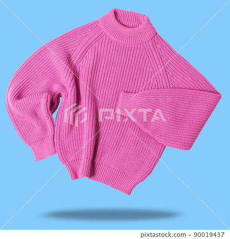 pink wool sweater, levitates as if dancing, casts a shadow, on a blue background 90019437