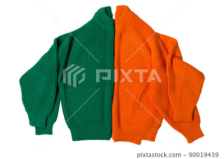 two wool sweaters, orange and green, folded in half as if it were one two-tone, on a white background two wool sweaters, orange and green, folded in half as if it were one two-tone, on a white background 90019439