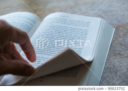Hands of people who turn over foreign books Hands of people who turn over foreign books 90023702