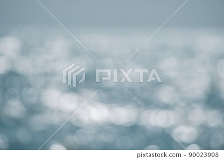 Abstract nature summer or spring ocean sea background. Small waves on golden warm water surface in motion blur with bokeh lights from sunset. Holiday, vacation and recreational background concept 90023908