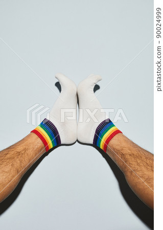 Playful Man in Rainbow Socks Closeup Playful Man in Rainbow Socks Closeup 90024999