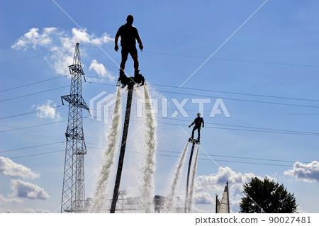 Two men on flyboards perform tricks. Extreme sports on the water 90027481