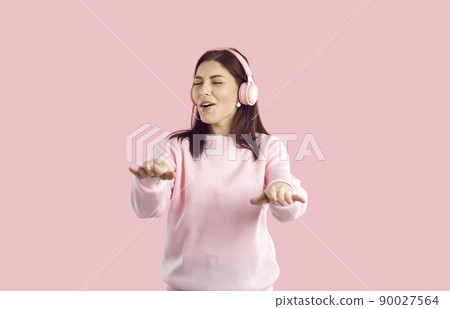 Happy woman listen to music in modern earphones Happy woman listen to music in modern earphones 90027564