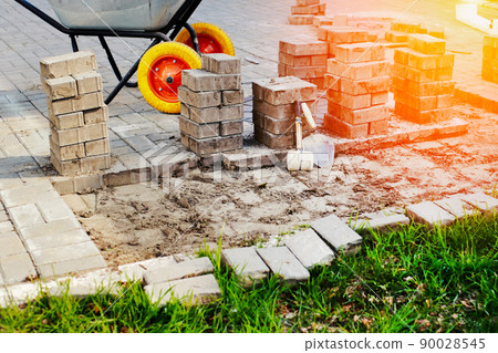 View of new paving slabs and concrete blocks on summer day at construction site. Stone blocks stand 90028545