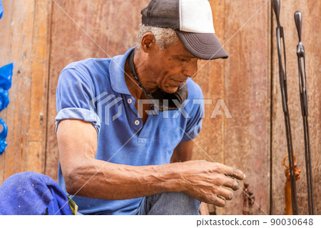 tired old afro american man sitting in the street tired old afro american man sitting in the street 90030648