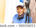 portrait of an afro american carver man in the street 90030653
