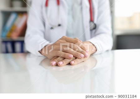 Professional general practitioner or cardiologist sits at table Professional general practitioner or cardiologist sits at table 90031184