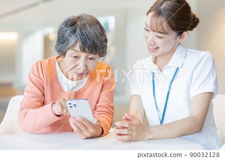 Senior female staff learning how to operate smartphones "LINK FOREST" Senior female staff learning how to operate smartphones "LINK FOREST" 90032128