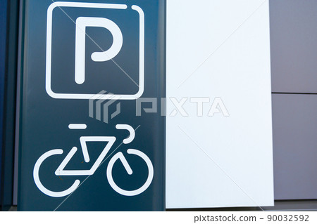 Symbol of a bicycle parking facility painted on the facade of a modern building 90032592