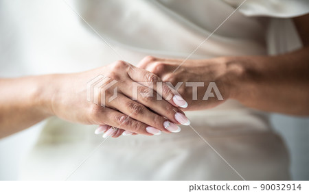 Detail of bride with perfect fingernails manicure done is ready for her wedding day Detail of bride with perfect fingernails manicure done is ready for her wedding day 90032914