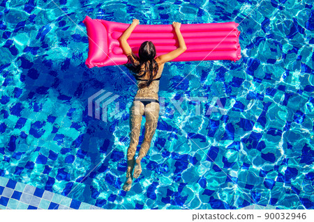 top view resort and spa vacation villa young woman swimming in the pool enjoying a sunny summer day in a tropical paradise top view 90032946