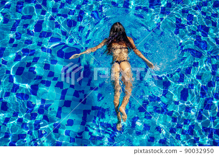 top view resort and spa vacation villa young woman swimming in the pool enjoying a sunny summer day in a tropical paradise top view 90032950
