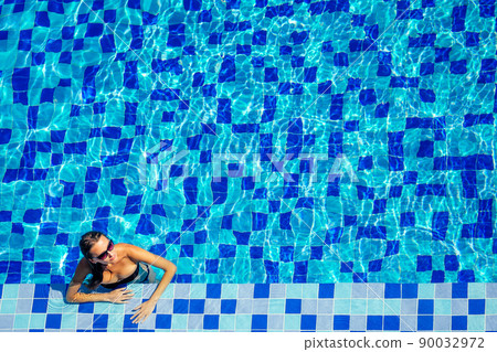 top view resort and spa vacation villa young woman swimming in the pool enjoying a sunny summer day in a tropical paradise top view top view resort and spa vacation villa young woman swimming in the pool enjoying a sunny summer day in a tropical paradise top view 90032972