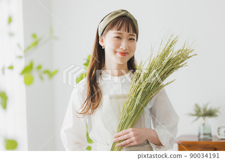 Woman with ear of rice 90034191
