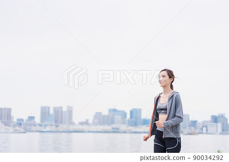 A woman running in the city 90034292