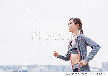 A woman running in the city 90034296