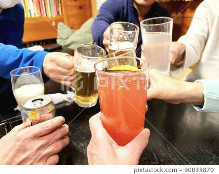 Multiple hands toasting with beer, juice and canned beer Multiple hands toasting with beer, juice and canned beer 90035870
