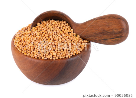 Mustard seeds in wooden bowl and spoon, isolated on white background. Pile of dry mustard grains. Mustard seeds in wooden bowl and spoon, isolated on white background. Pile of dry mustard grains. 90036085