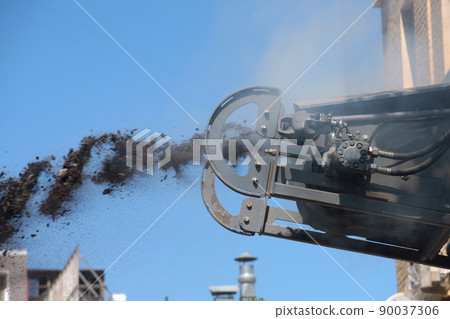 Road milling vehicle removes old asphalt and loads milled asphalt into dump truck. Road milling vehicle removes old asphalt and loads milled asphalt into dump truck. 90037306