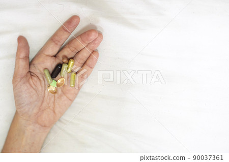 Close up supplement food in hand. Health care concept on white background. Close up supplement food in hand. Health care concept on white background. 90037361